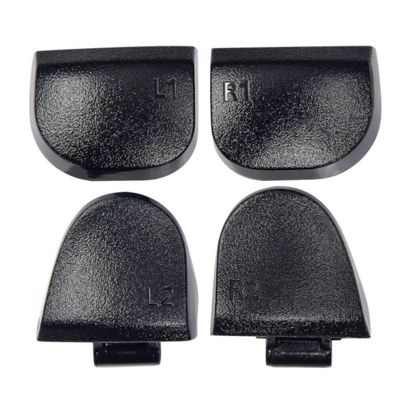Four black PS5 DualSense replacement buttons labelled L1, R1, L2 and R2, shown from the front and rear with their mounting structures visible - THARAA STORE