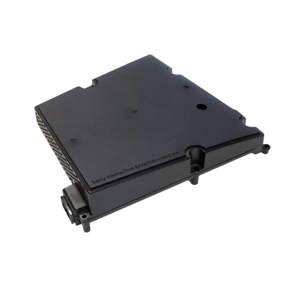 Black ADP-400JR internal power supply for a compatible PS5 Slim console, shown from multiple angles with ventilation holes, mounting points, and AC power inlet - THARAA STORE